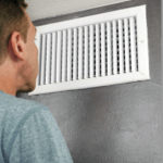 man cleaning air duct